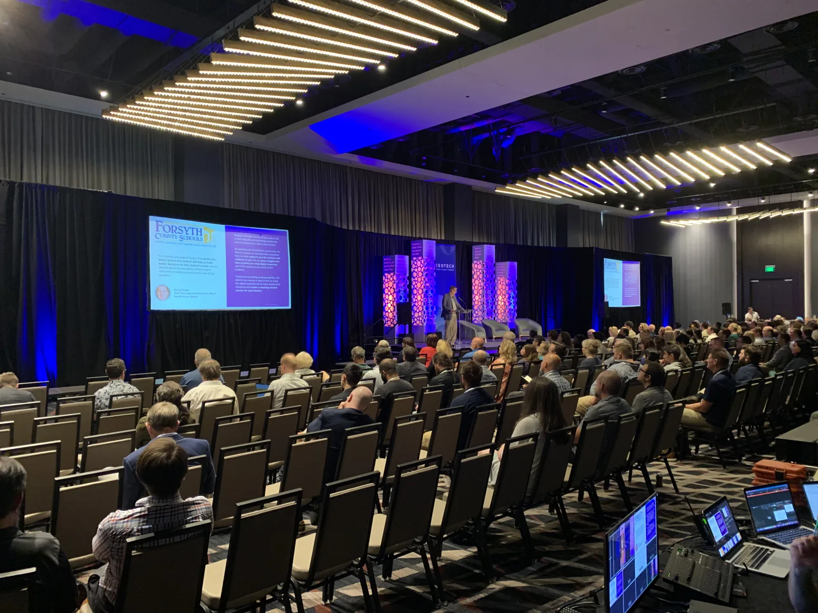 1EdTech conference general session at the Grand Hyatt Nashville — dual Epson projection screens, gobo-lit stage scenery and a full seated audience produced by Nashville Audio Visual