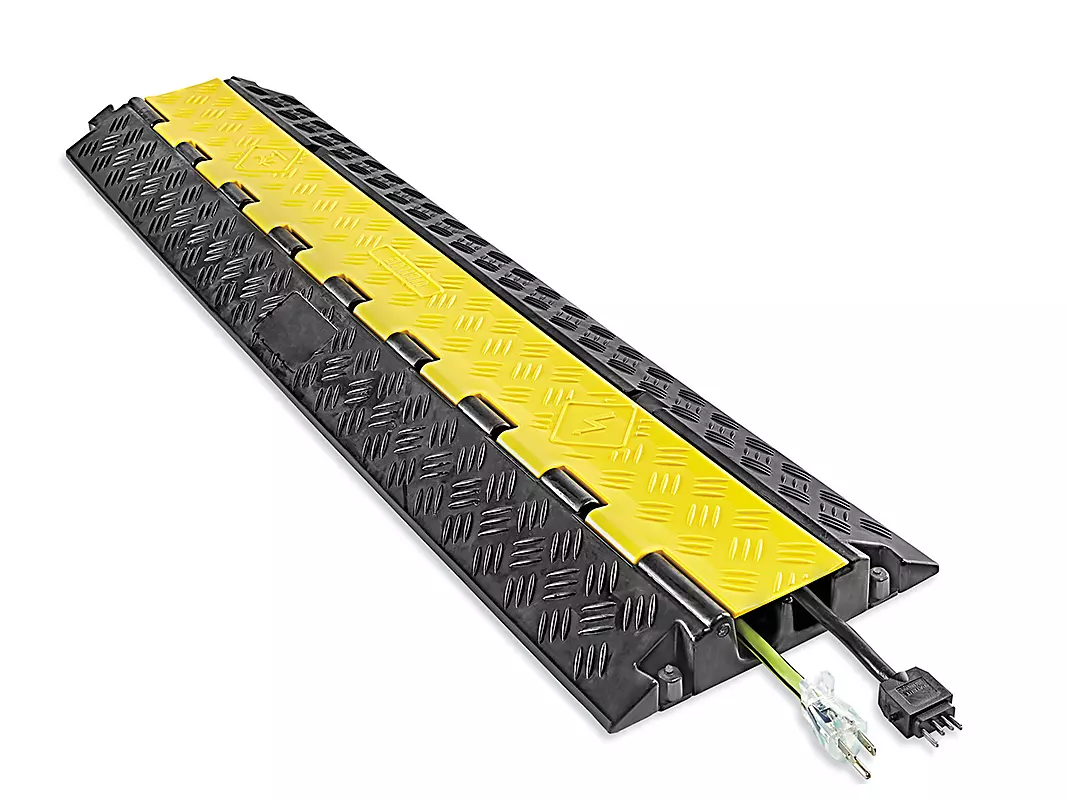 Yellow and black cable ramp protecting power and signal cables at an event