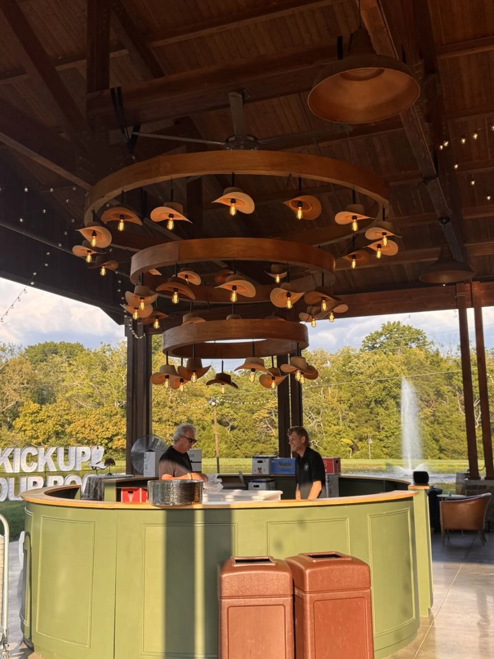 Dye Collective launch event at The Barn at Sycamore Farms — timber pavilion, cowboy hat chandelier, green bar and lake at sunset, produced by Nashville Audio Visual